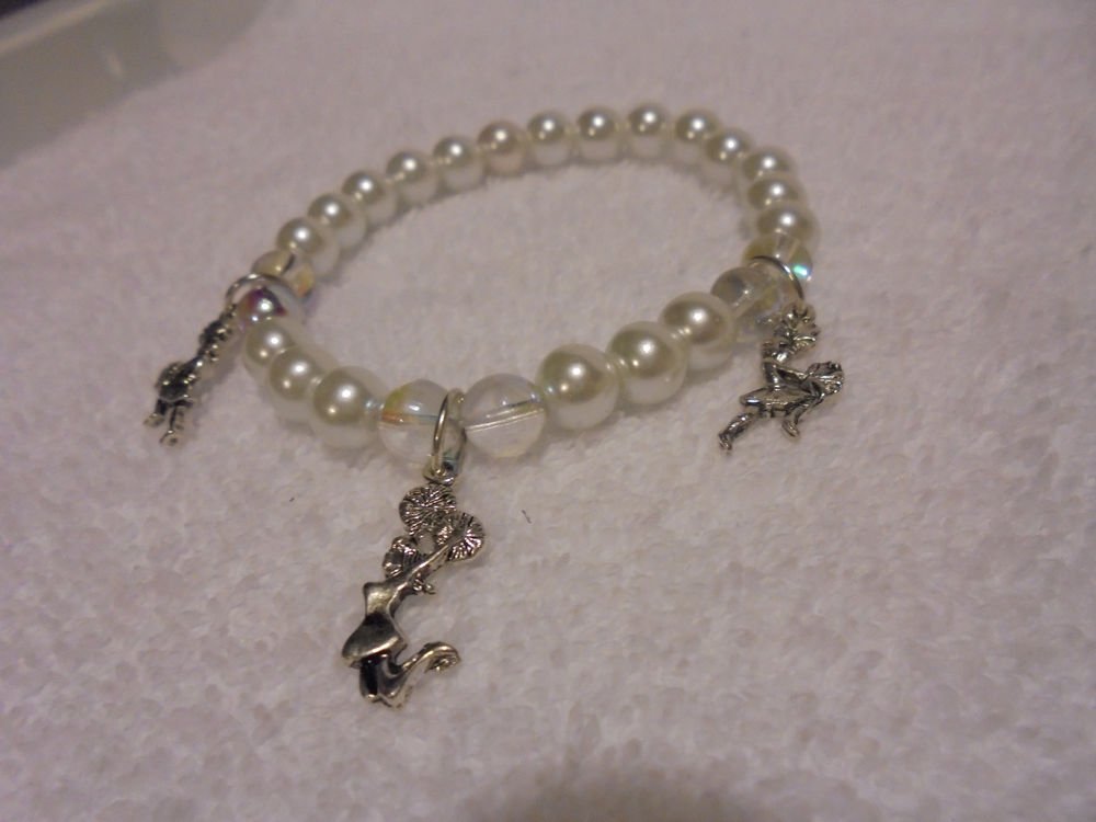"THREE CHEERLEADER" CHARMS ON A WHITE EXPANDABLE BEADED BRACELET....CUTE