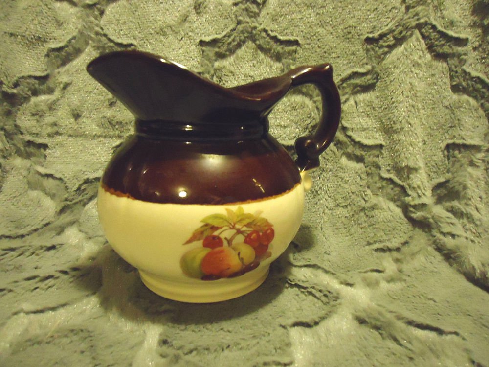 McCOY SMALL BROWN & BEIGE PITCHER WITH FRUIT DESIGNS....APPROX 6" TALL