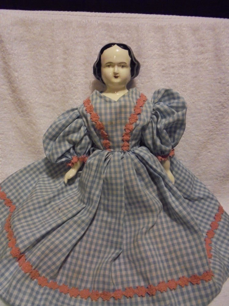 ANTIQUE PORCELAIN PAINTED MOLDED BLACK HAIR DOLL ....APPROX 14" TALL...UNIQUE