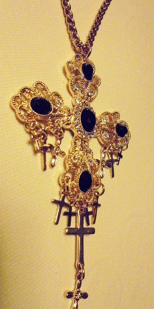 LARGE GOLDTONE/RHINESTONE/FLIIGREE CROSS...6 OTHER CROSSES HANGING FROM IT..
