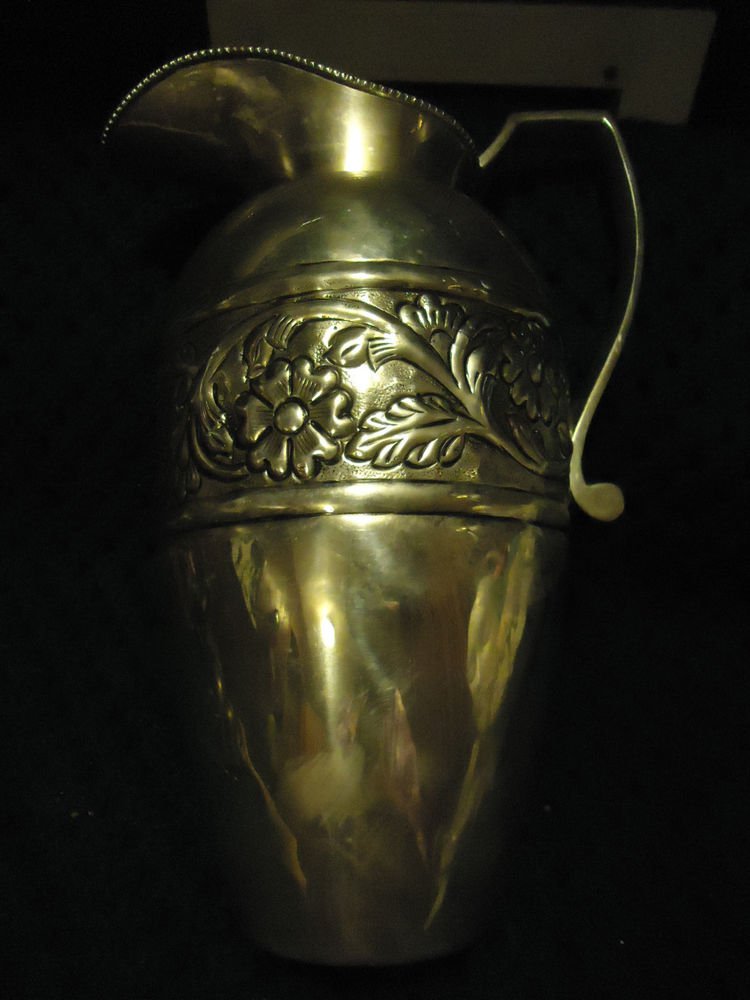 SILVER METAL PITCHER WITH BEAUTIFUL FLOWERS AROUND CENTER..MADE IN INDIA...HEAVY