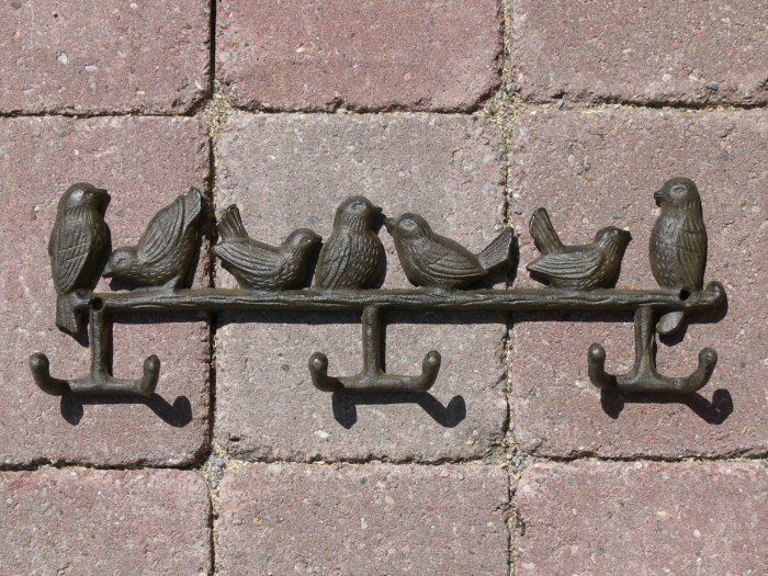 Coat Rack With Birds Perched.