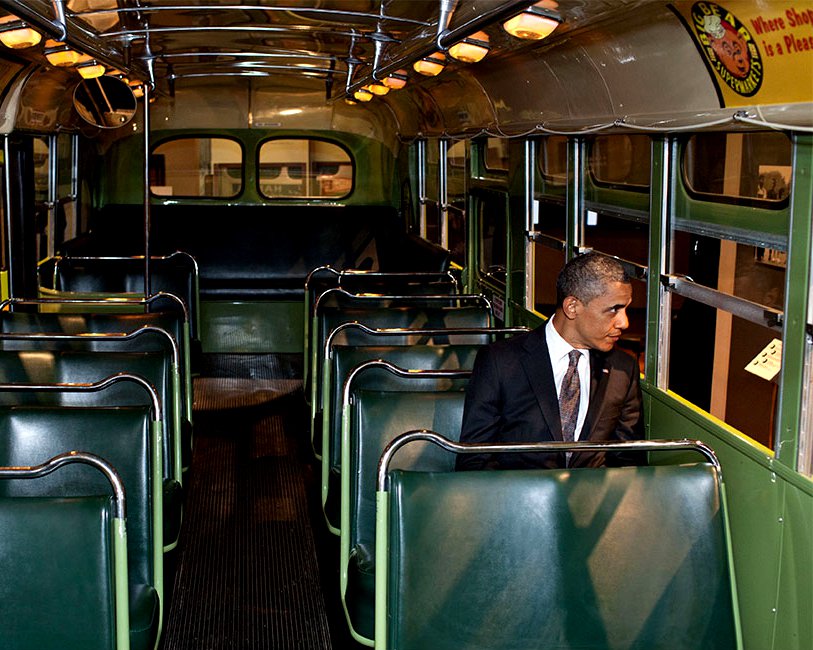 PRESIDENT BARACK OBAMA SITS ON SEAT IN 'ROSA PARKS BUS' - 8X10 PHOTO (DD-046)