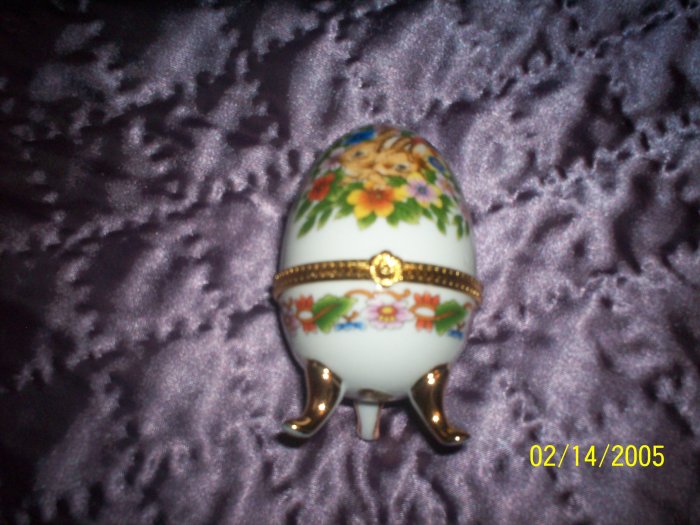 Egg shaped trinket w/ bunnies and flowers.j