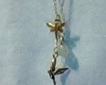 Gold necklace with a bird, jewel, and dragonfly charms - 18 inch chain