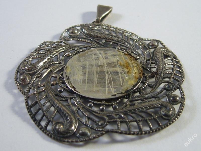 Old silver pendant for a photo