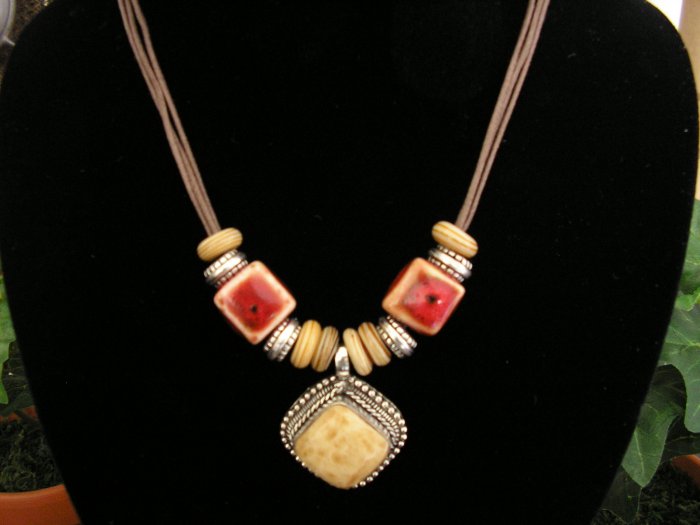 Brown Cord with clay beads and bone pendant.