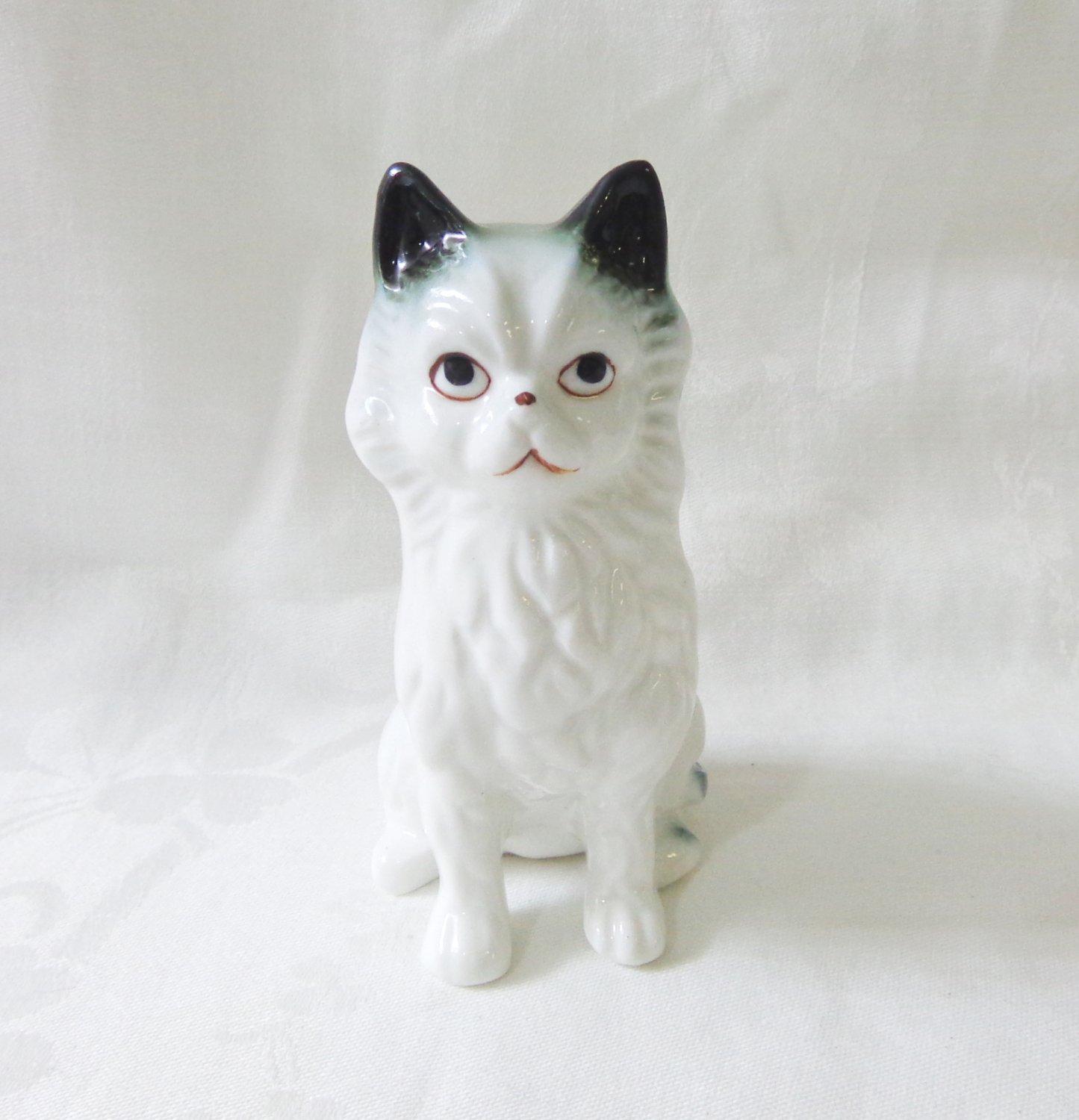 white ceramic cat figurine