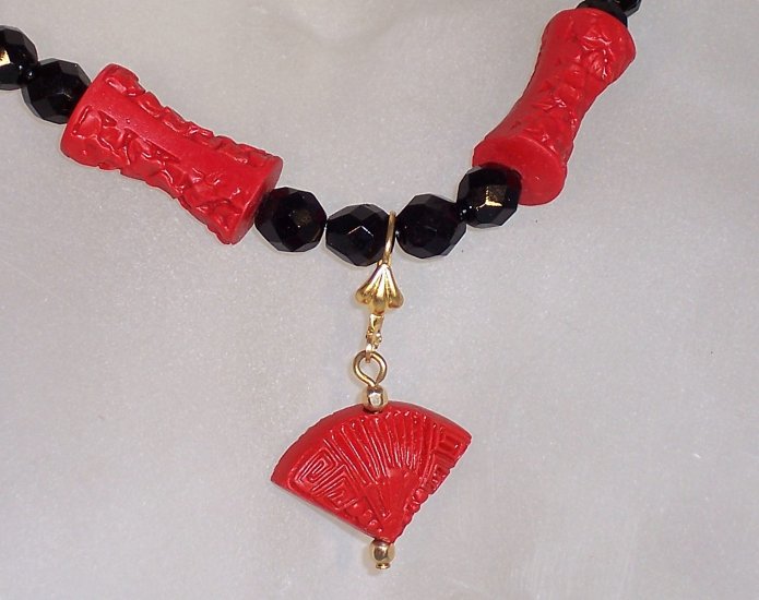 Carved "cinnabar" with jet beads
