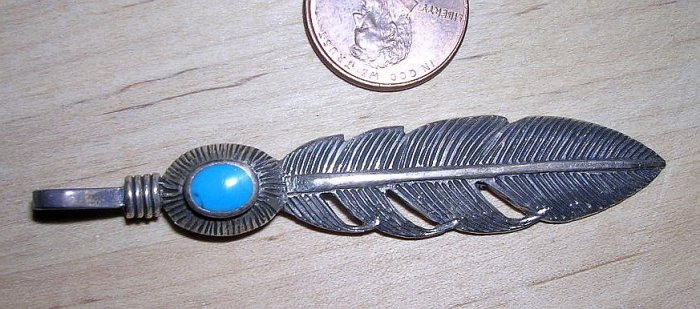 Silver feather pendant with turquoise accent