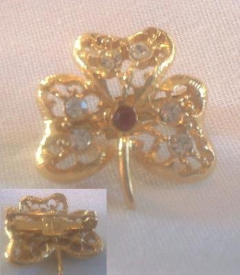 GOLD SHAMROCK BROOCH WITH CRYSTAL & RED STONES