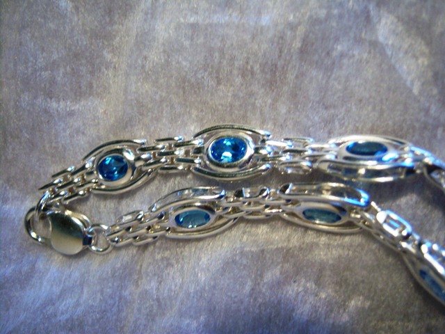 Sterling Silver handmade link bracelet with Blue Topaz gemstones.