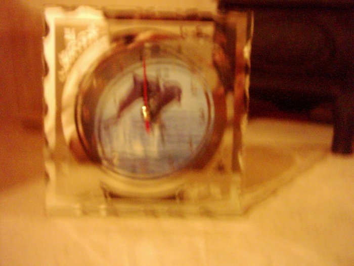 small clock with dolphins