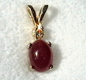 Ruby cabochon and round cz pendant in 14kt solid gold