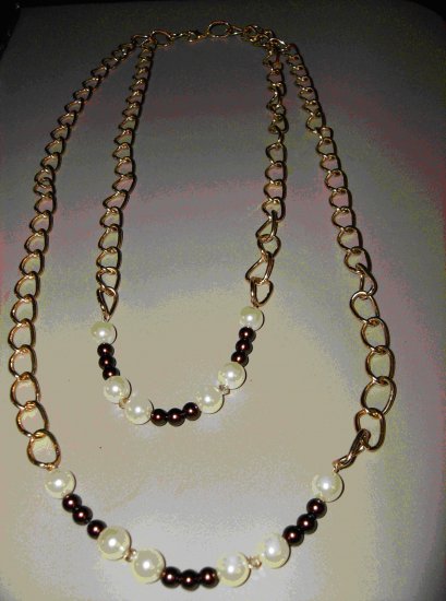 2 strand gold chain featuring cream and burgundy pearls