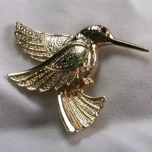 Gold tone Hummingbird pin with red crystal eye