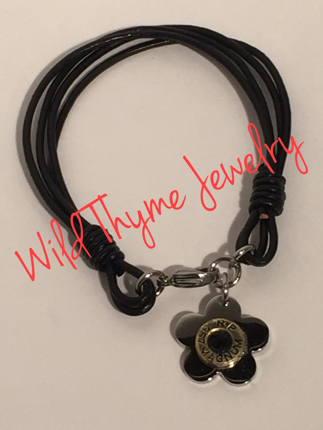 Leather bracelet with flower and bullet casing charm