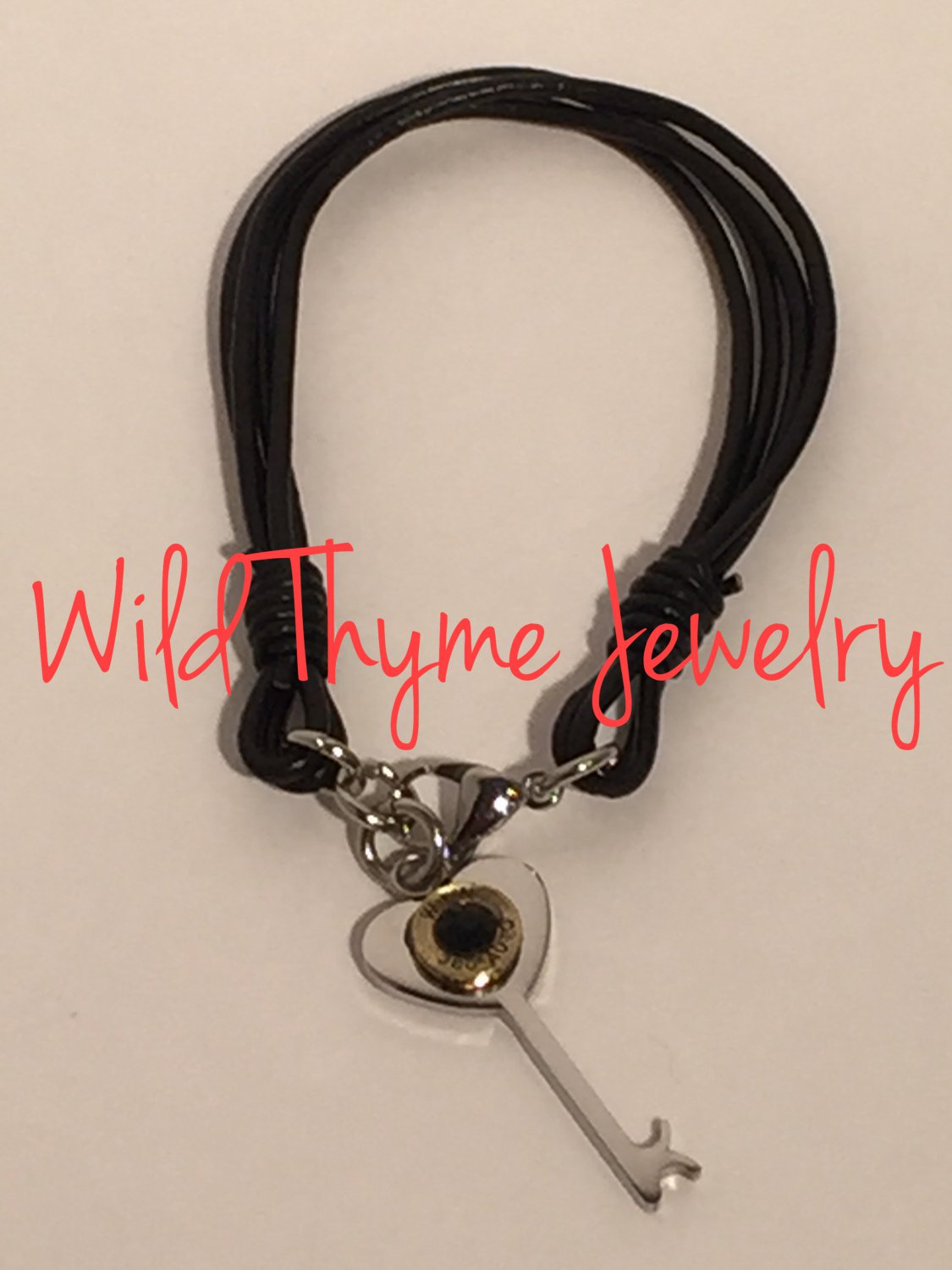 Leather bracelet with heart key and bullet charm
