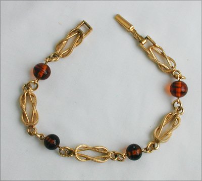 Avon tooled gold tone amber plastic bead bracelet