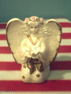 "Knelling Angel holding a Dove"