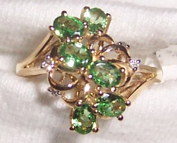 Green stone ring with diamond accents