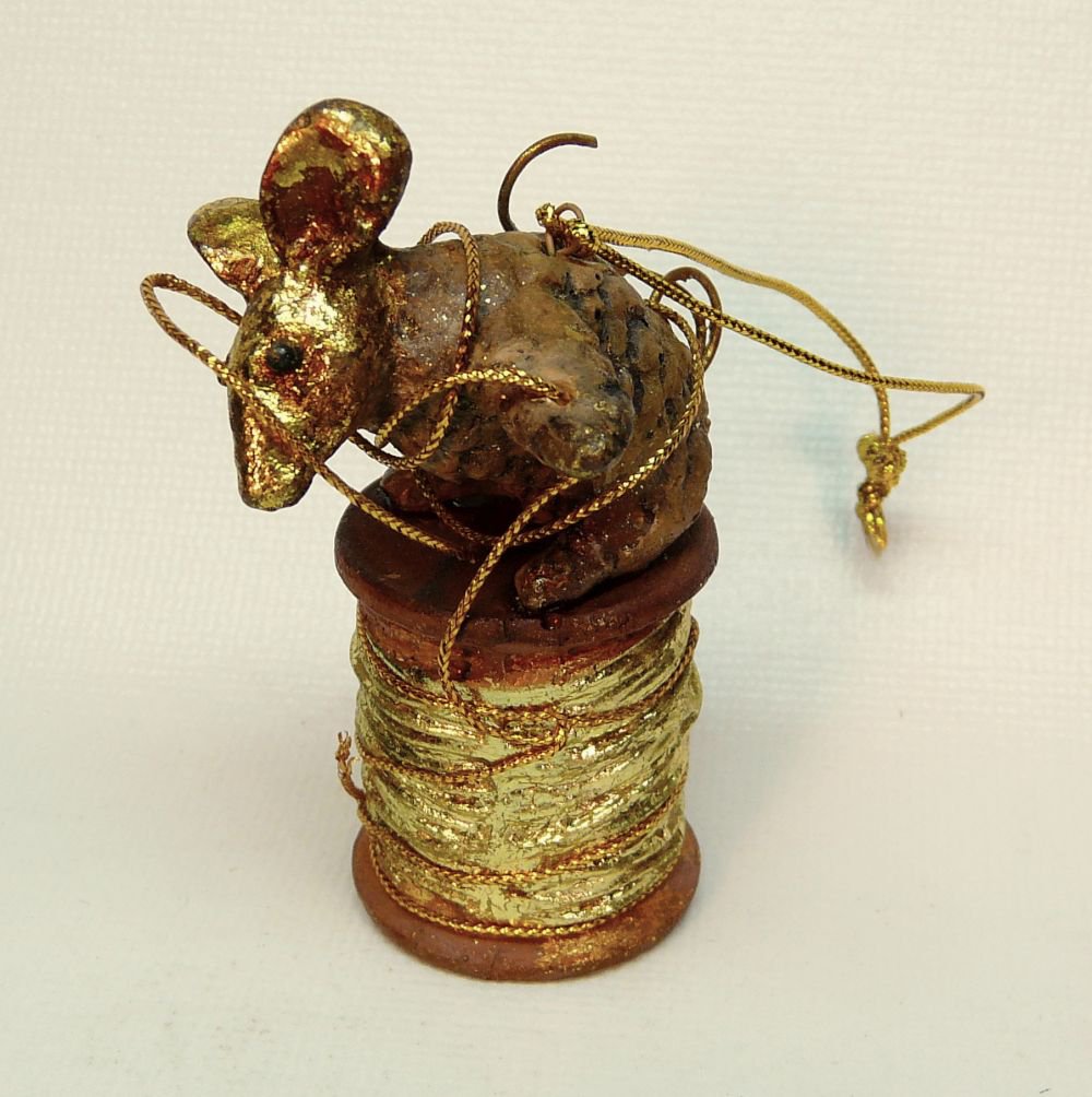 mouse christmas ornament sitting on spool of thread mouse christmas ornament sitting on spool of thread
