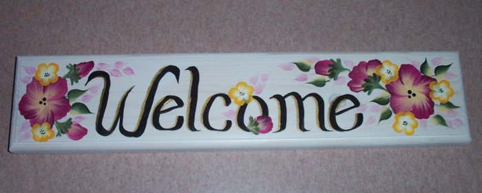 welcome sign with burgundy & small yellow flowers
