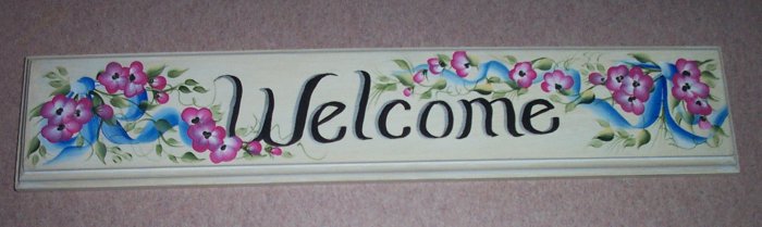 welcome wilth painted blue ribbon & small pink flowers