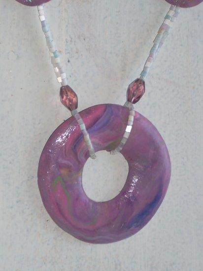 Purple Clay and seed beads.