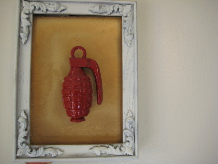 red grenade on gold and white