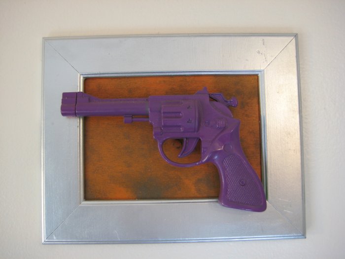 purple gun on orange and silver