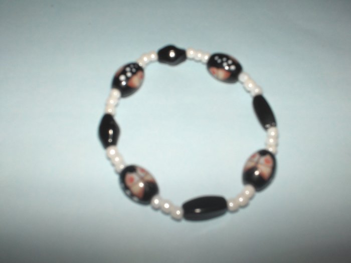 Black glass bead stretch bracelet with butterfly design