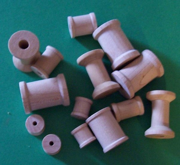 Lot of ten new wooden spools in assorted sizes