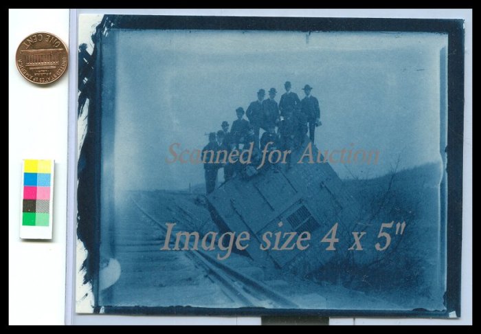 Photograph of rolled, wrecked railroad box car