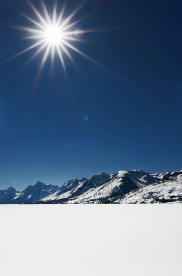 Sunburst Over a Frozen Jackson Lake
