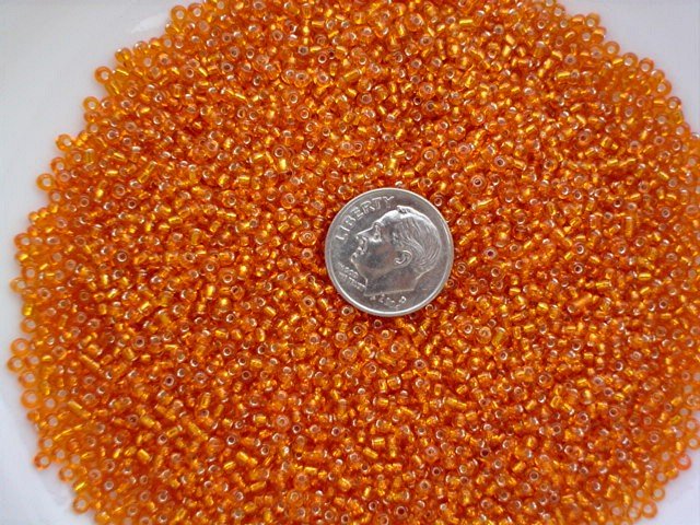 Size 11 Celestial silver lined beads orange 15 grams