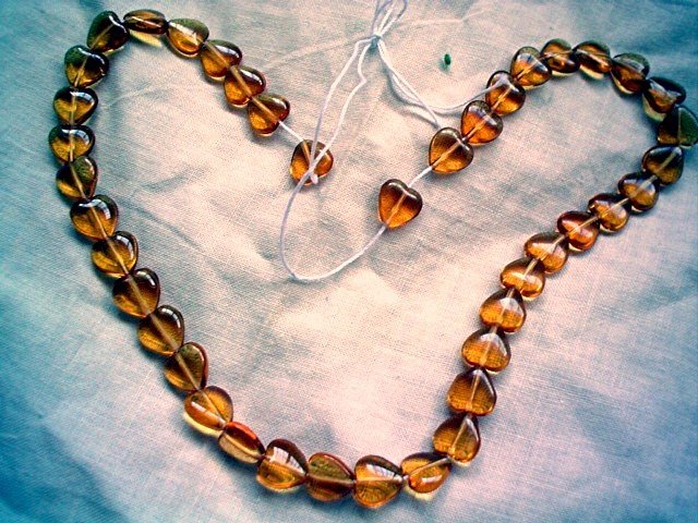 Pressed glass beads amber puffed heart 10 mm 16 inch strand