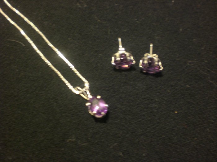 Genuine Amethyst set in sterling silver settings and pendant is on a sterling silver chain
