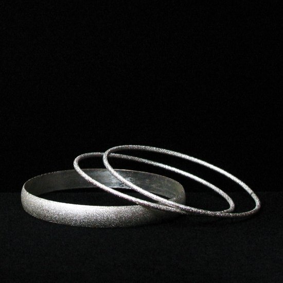 pebbly silvertone fireworks bangles - vintage jewelry