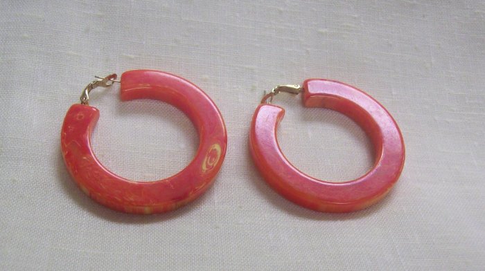 Fashion Jewelry, a pair of large orange pierced hoop earrings