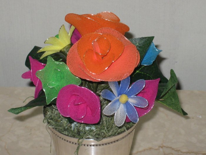 roses arranged in a silver wedding tumbler