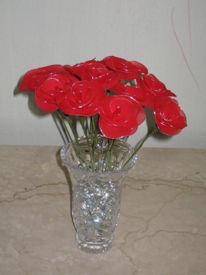 dozen roses arranged in a crystal vase