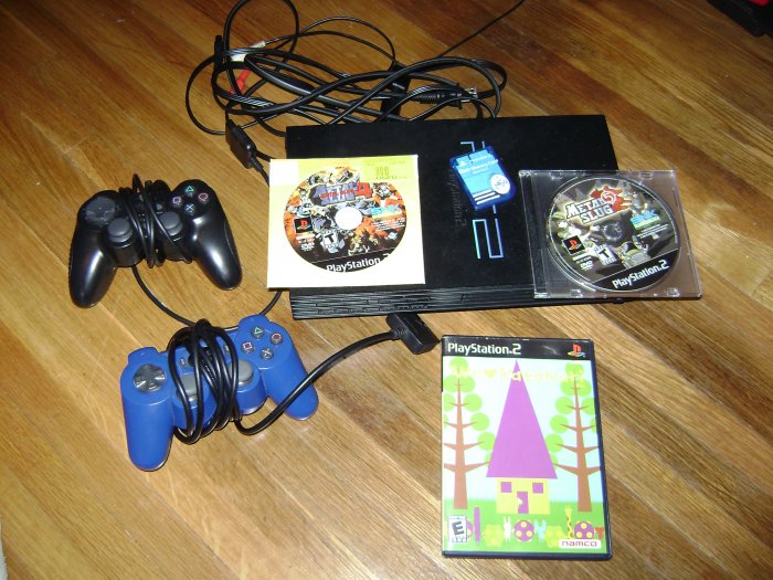 Sony Playstation 2 with 2 controllers and 3 games