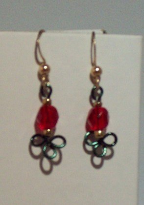 green shamrock with read beads