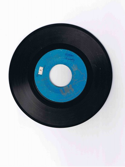 First Class (John Carter) 45rpm single, "Beach Baby" / "Both Sides of the Story" (UK Records)