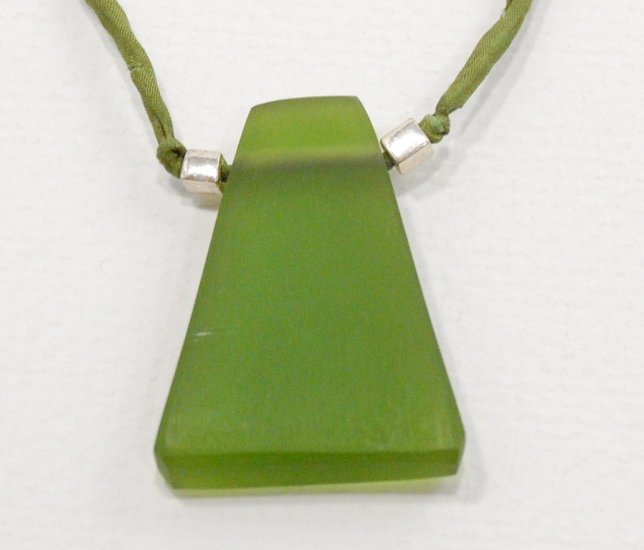 Green resin pendant on green silk cord