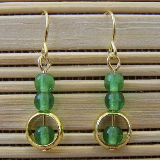 gold ring and emerald green glass dangle earrings