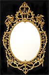George III period, oval, carved giltwood mirror