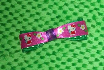 Green polka dot and hello kitty bow super cute with snap clip on back