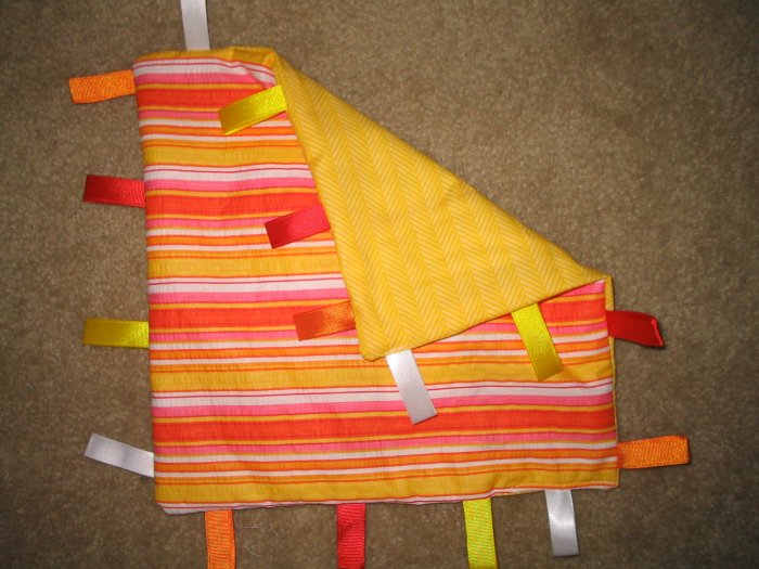 Orange taggies for baby - crib toy